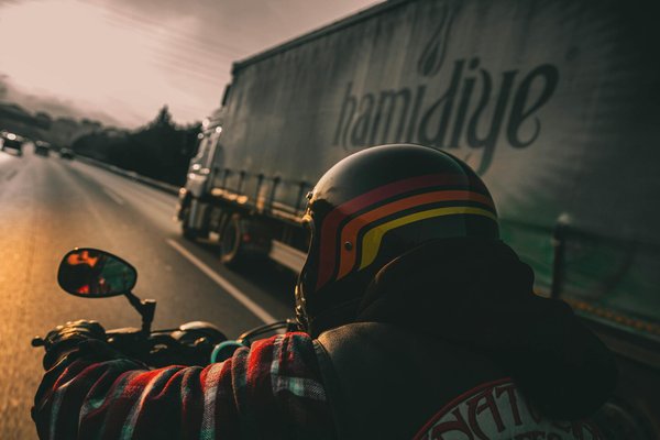 How do you prepare for varying road conditions while riding a motorcycle?